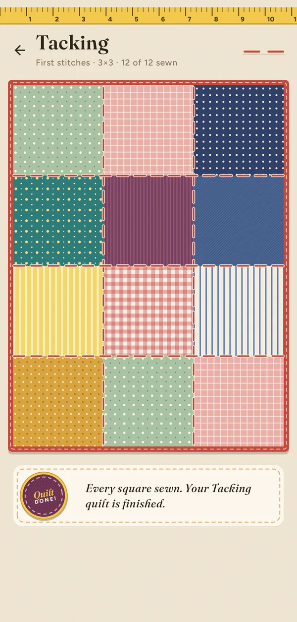 The finished Tacking quilt, twelve fabric squares stitched together with a red binding